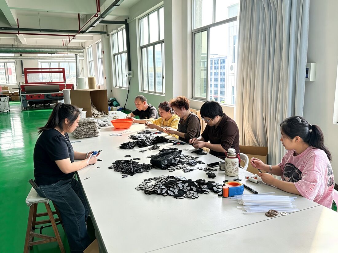 LOCACRYSTAL Pujiang handcraft team assembling rhinestone trim by hand at long worktable