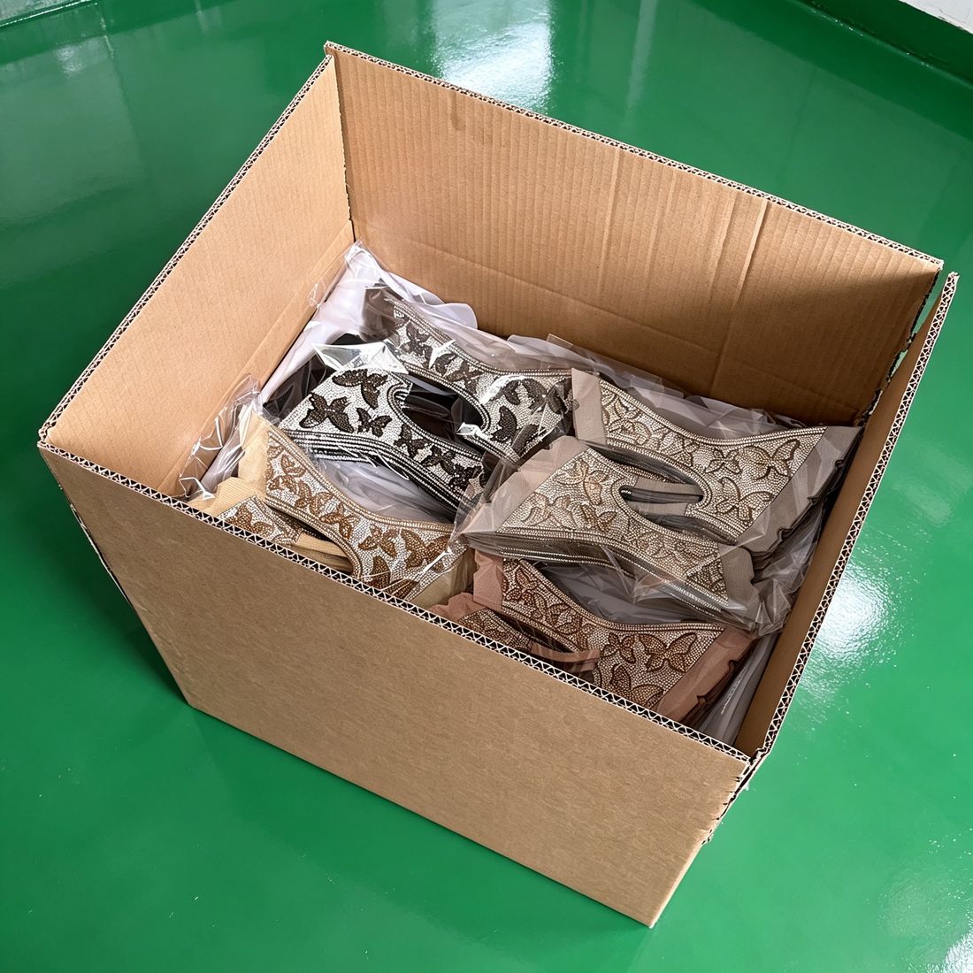 LOCACRYSTAL Shoe Upper bulk shipment carton with gold butterfly motif vamps prepared for export