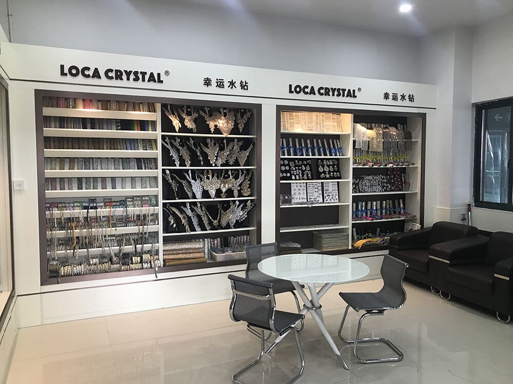LOCA CRYSTAL brand wall inside the Yiwu showroom — display cabinets with diamond flowers, bangle stickers and trim rolls